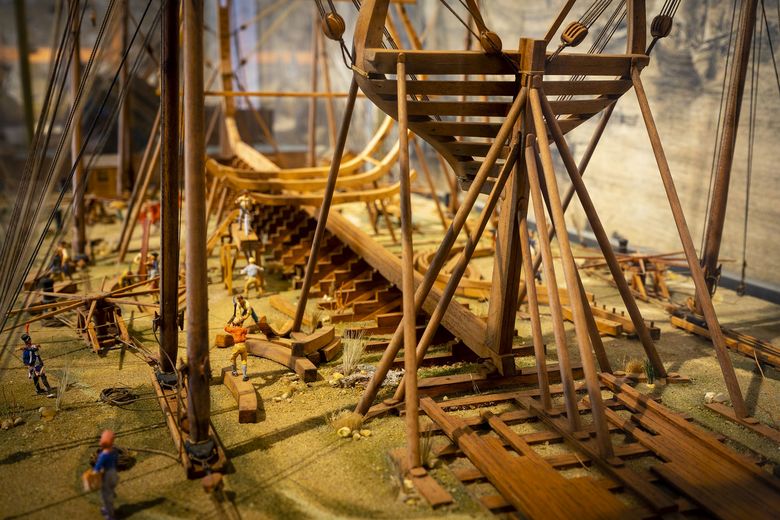 A miniature model of a shipyard with a wooden ship under construction