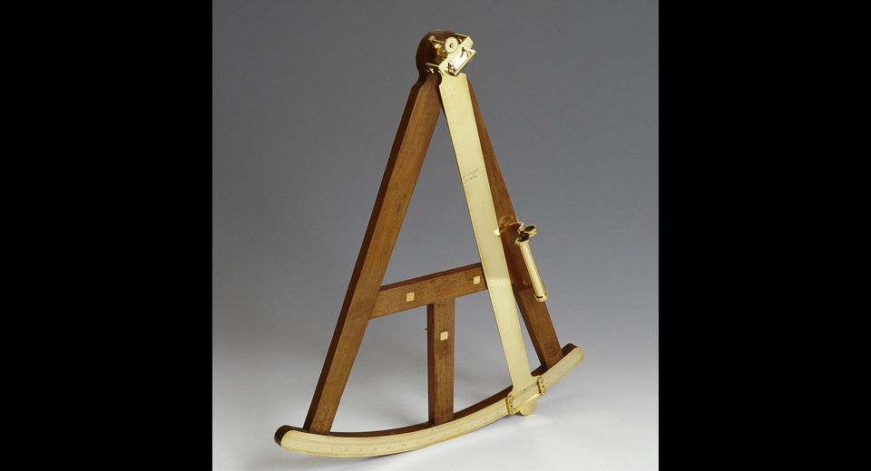 An antique wooden octant with brass handle, arc, scale, index arm and telescope