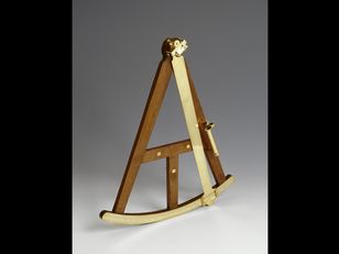 An antique wooden octant with brass handle, arc, scale, index arm and telescope