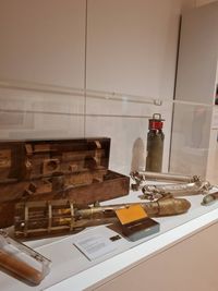 Vitrine d’exposition présentant un bathythermographe mécanique au premier plan, avec ses composants en laiton et acier, accompagné d’autres instruments océanographiques et de leur coffret en bois, Musée national de la Marine.