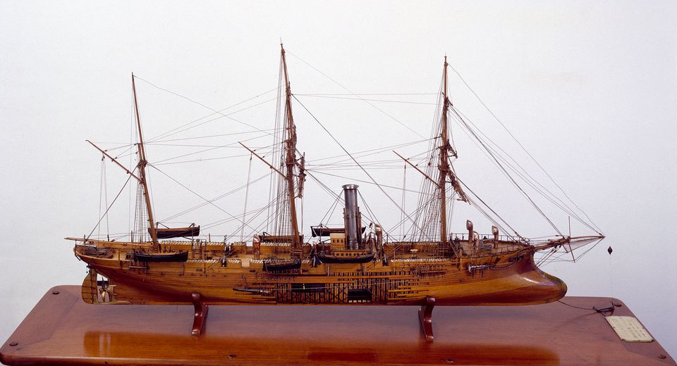  model ship with a wooden hull and a steam engine, on a wooden base with a plaque