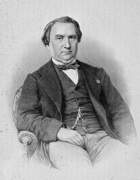 Portrait of Henri Dupuy de Lôme, naval engineer, seated in dark suit, photograph by Pierre-Louis Pierson, 1888.