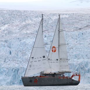 Schooner Persévérance of Jean-Louis Étienne sailing in front of an ice wall during the Arctic expedition.
