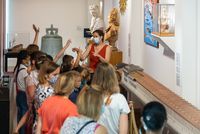 Enfant et médiatrice devant la maquette de la corderie